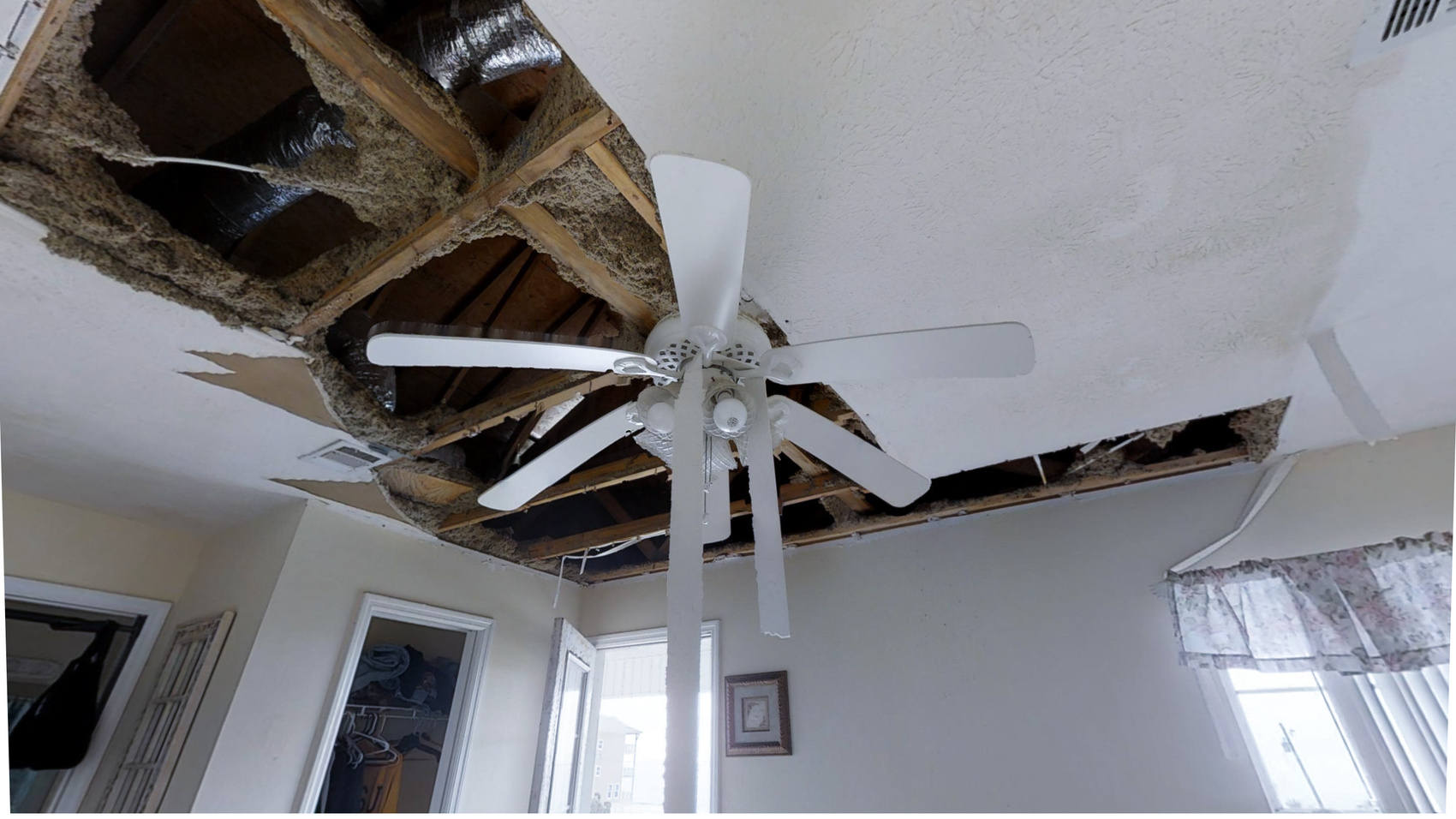 damaged ceiling with ceiling fan